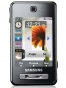 Fotografías Frontal de Samsung F480 Negro. Detalle de la pantalla: Reloj y Pantalla de inicio